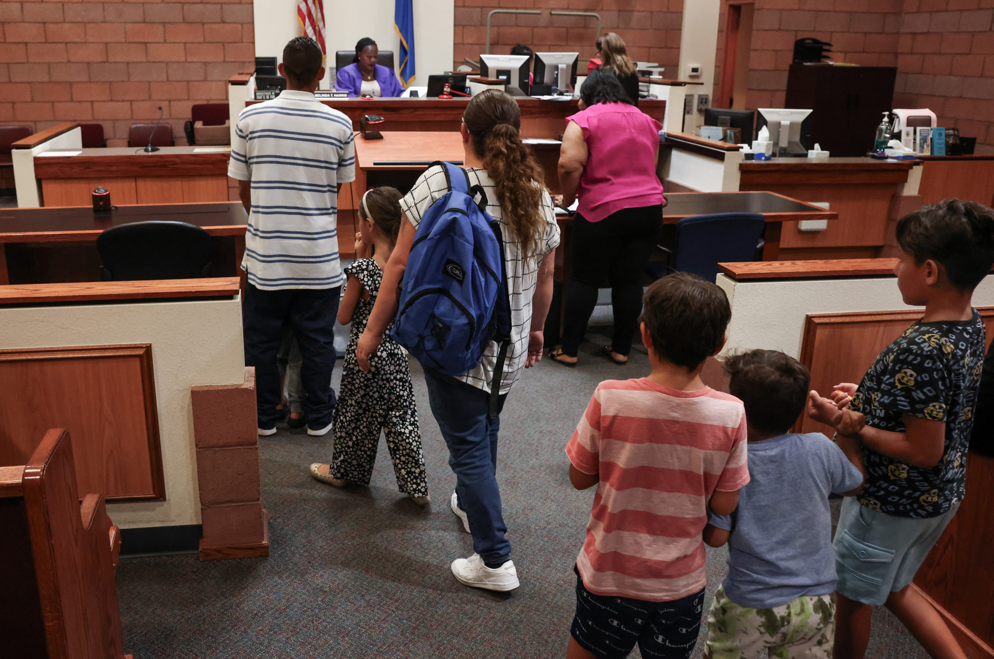 Defendants Edward and Lizette Gallegos with their children stands in front of North Las Vegas Justice of the Peace Belinda T. Harris during a home eviction hearing on Tuesday, July 18, 2023. (Jeff Scheid/The Nevada Independent)